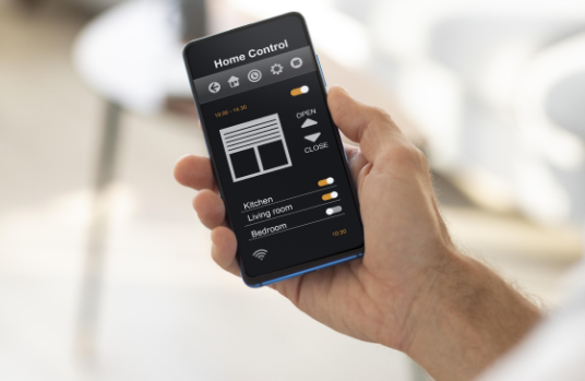 man holding smartphone with home automation app